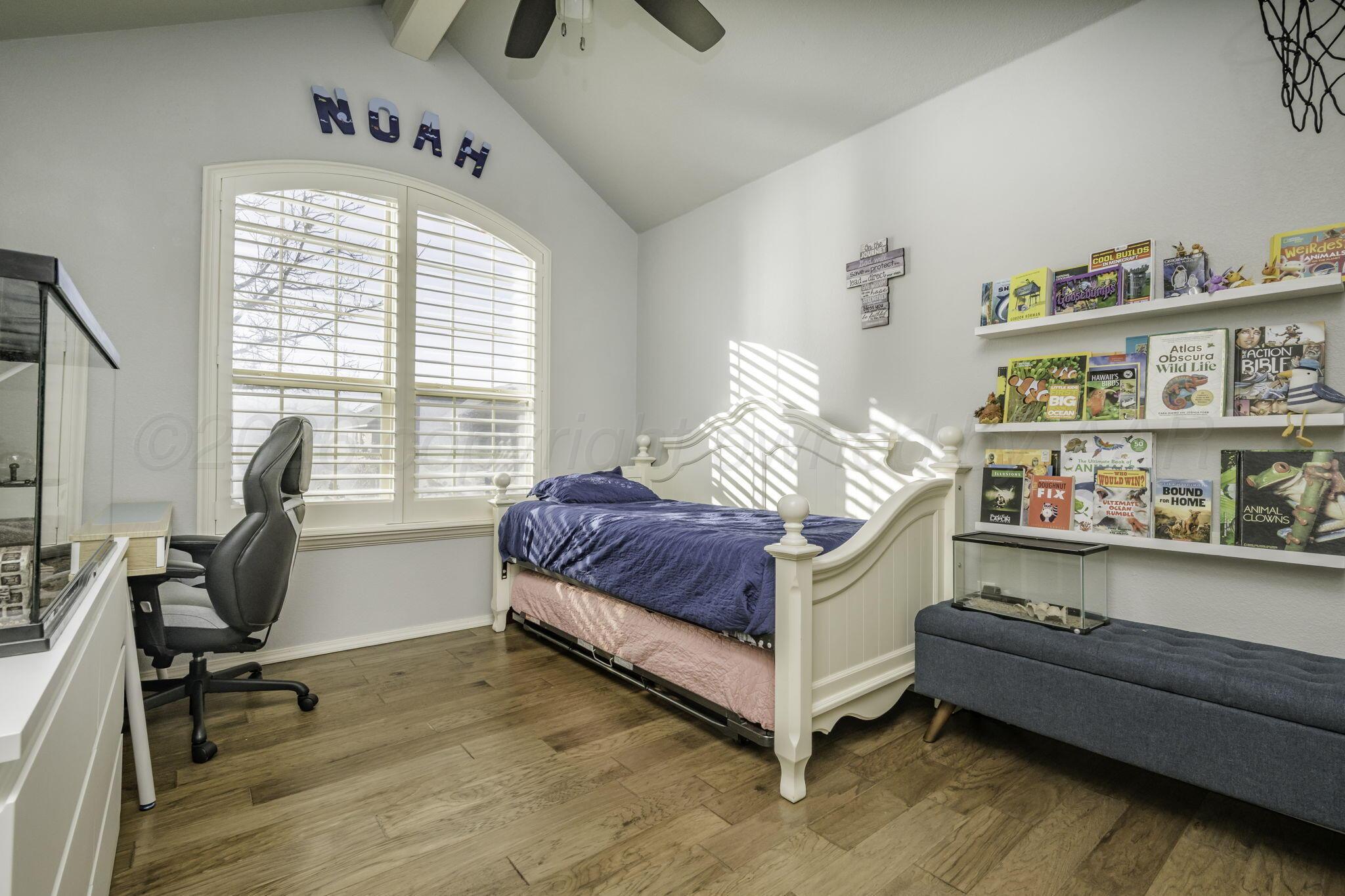 3504 Springfield Avenue Amarillo, TX 79118 - Photo 14 of 23 a bedroom with a bed and a large window