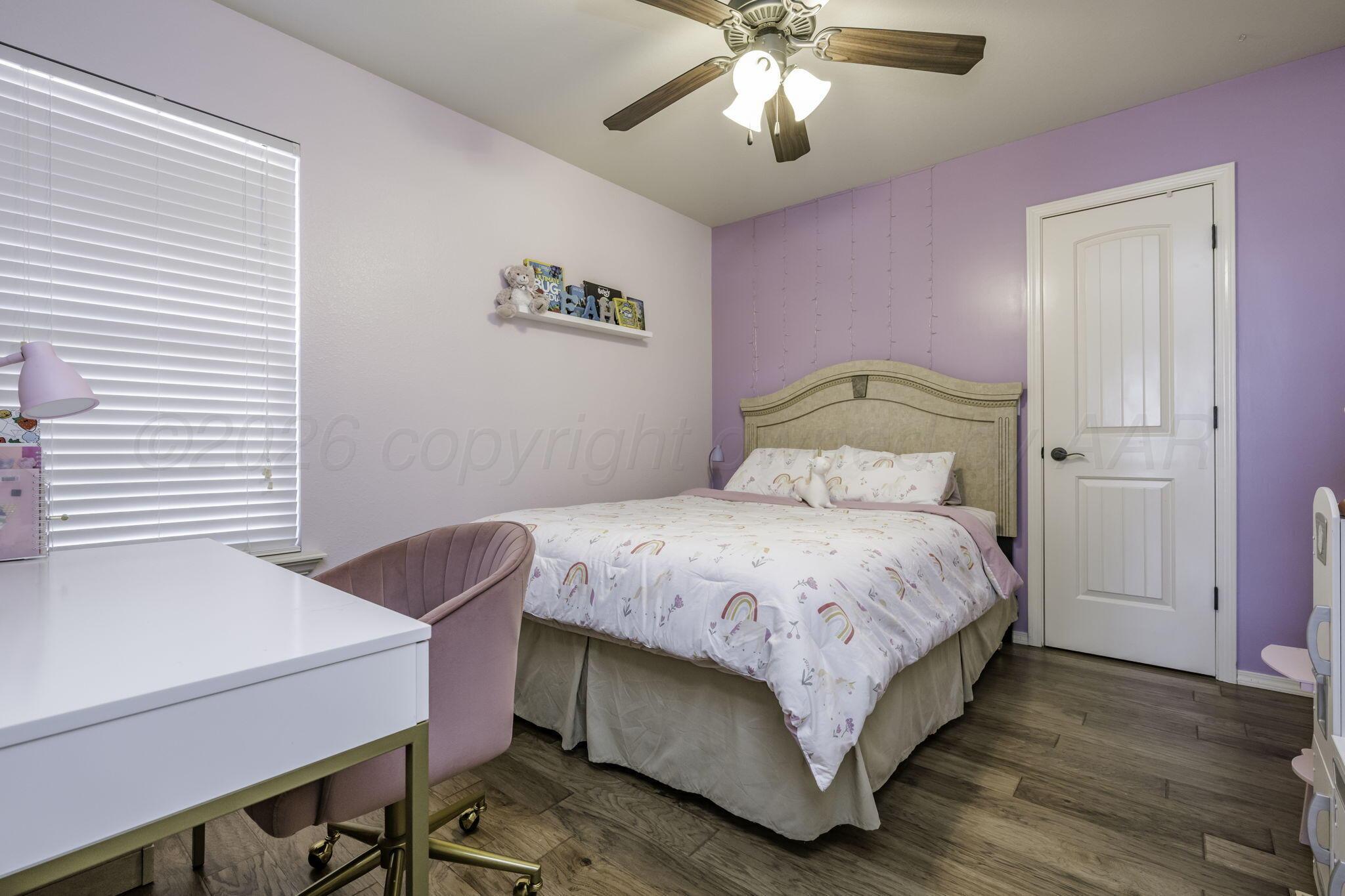 3504 Springfield Avenue Amarillo, TX 79118 - Photo 16 of 23 a bedroom with a bed and a chandelier