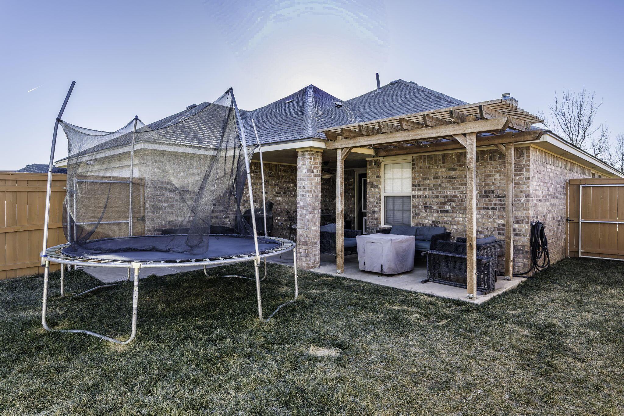3504 Springfield Avenue Amarillo, TX 79118 - Photo 19 of 23 a view of a wooden chairs and table in a backyard