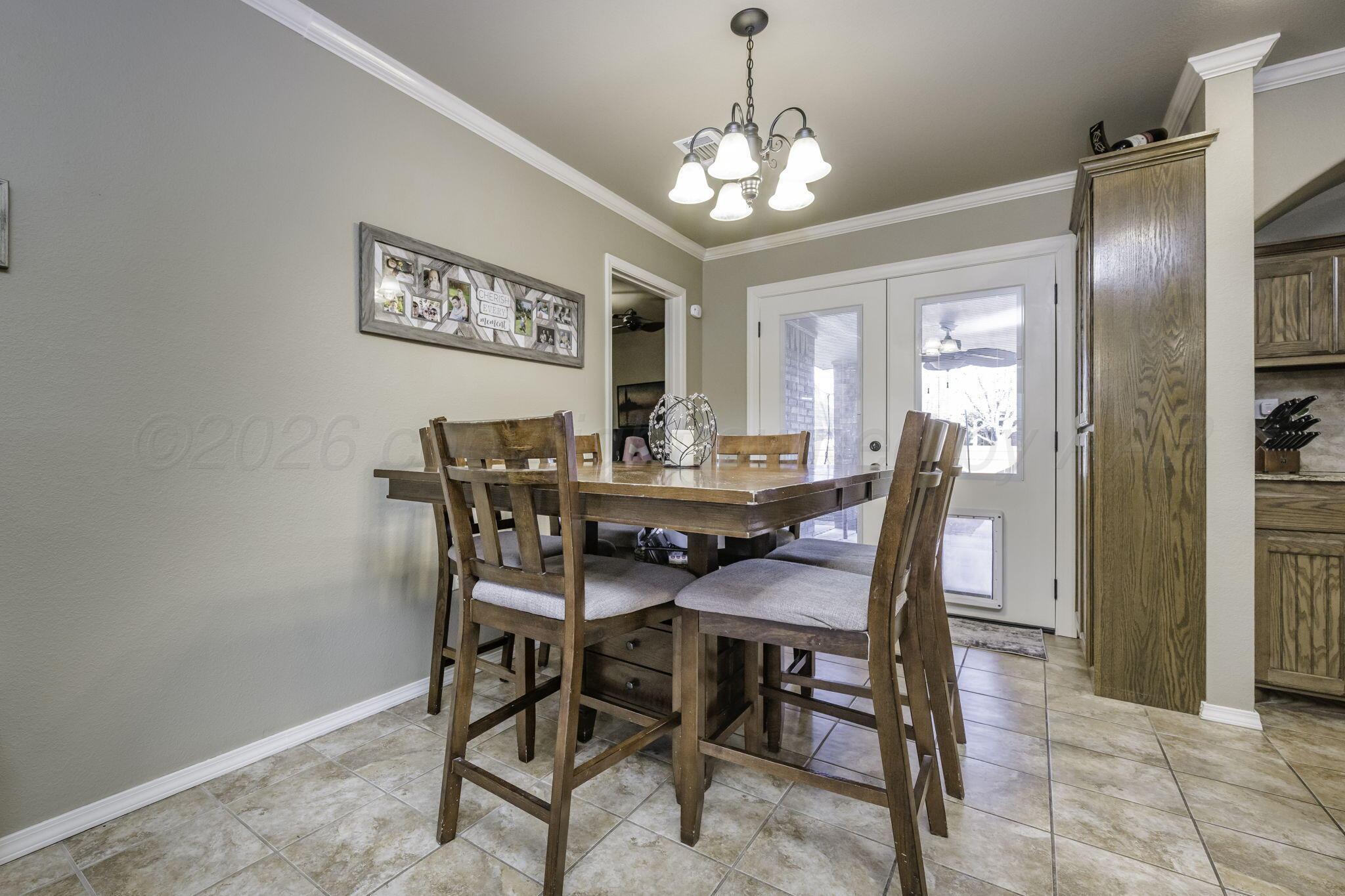 3504 Springfield Avenue Amarillo, TX 79118 - Photo 6 of 23 a view of a dining room with furniture and a chandelier