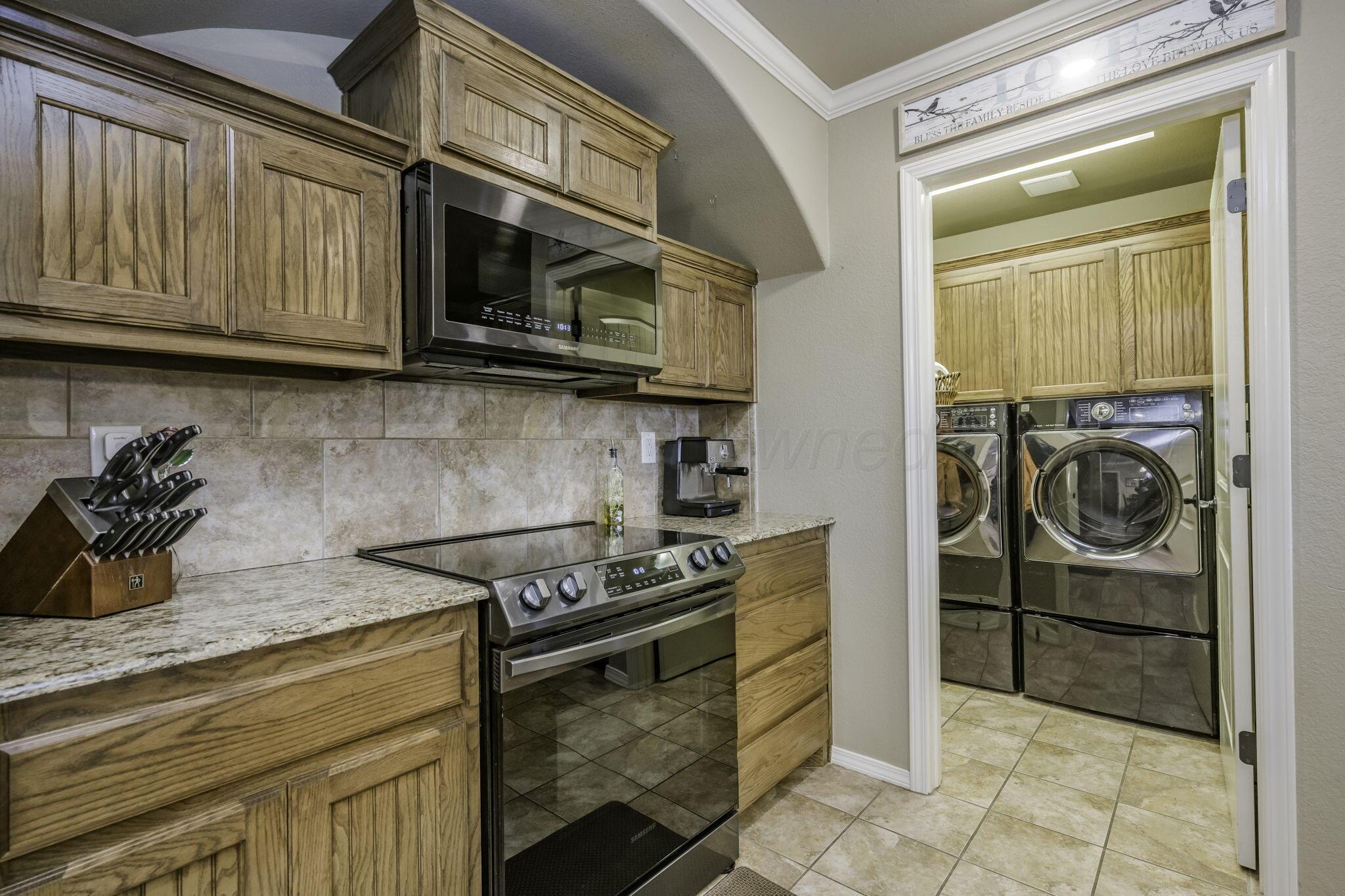3504 Springfield Avenue Amarillo, TX 79118 - Photo 8 of 23 a kitchen with stainless steel appliances granite countertop a stove and a microwave