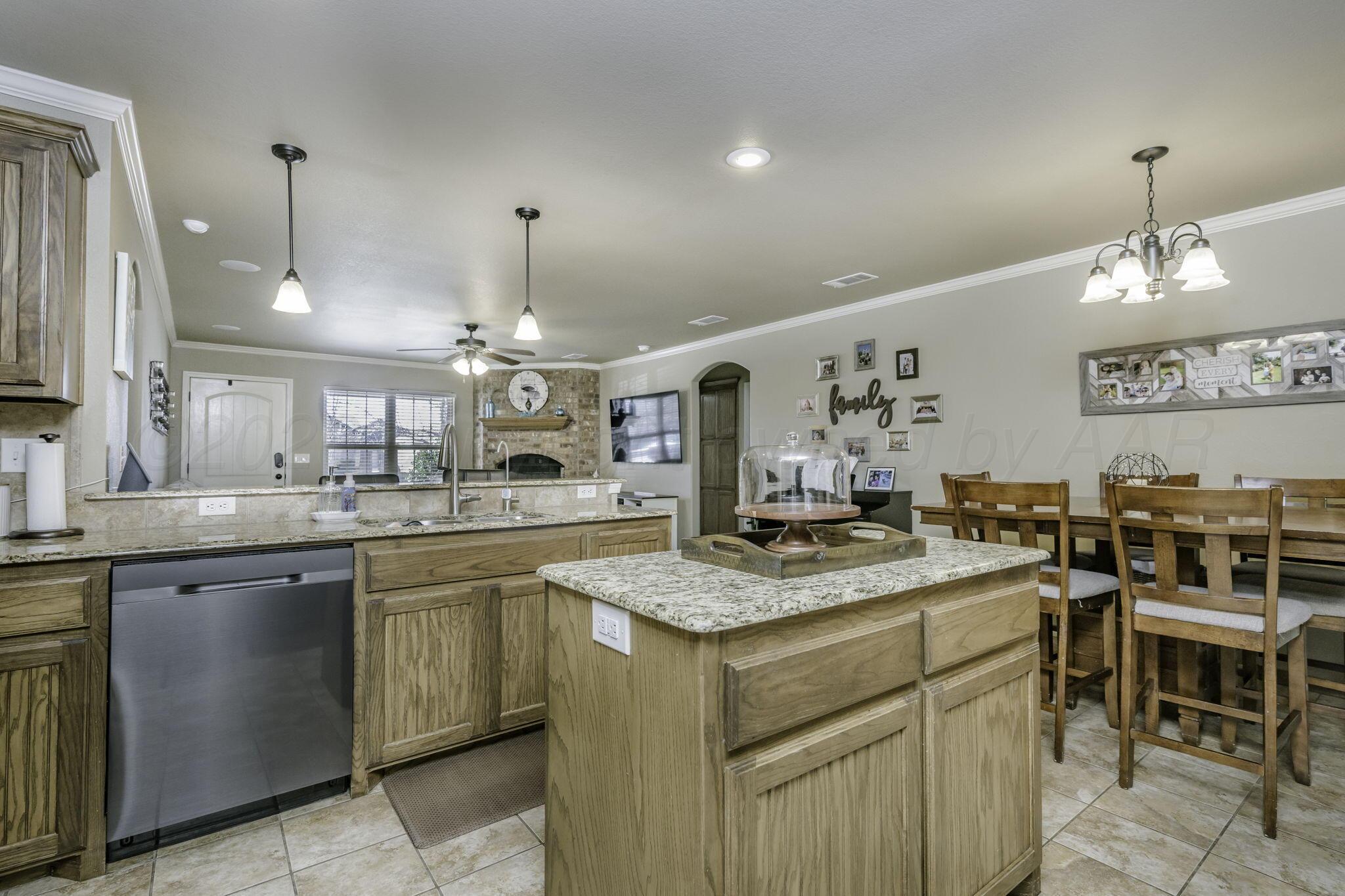 3504 Springfield Avenue Amarillo, TX 79118 - Photo 9 of 23 a kitchen with a stove a sink a dining table and chairs