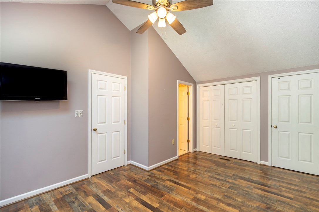 1302 Leeward Road Anderson, SC 29625 - Photo 18 of 50 This spacious bedroom offers high vaulted ceilings and beautiful wood flooring, creating an inviting retreat.