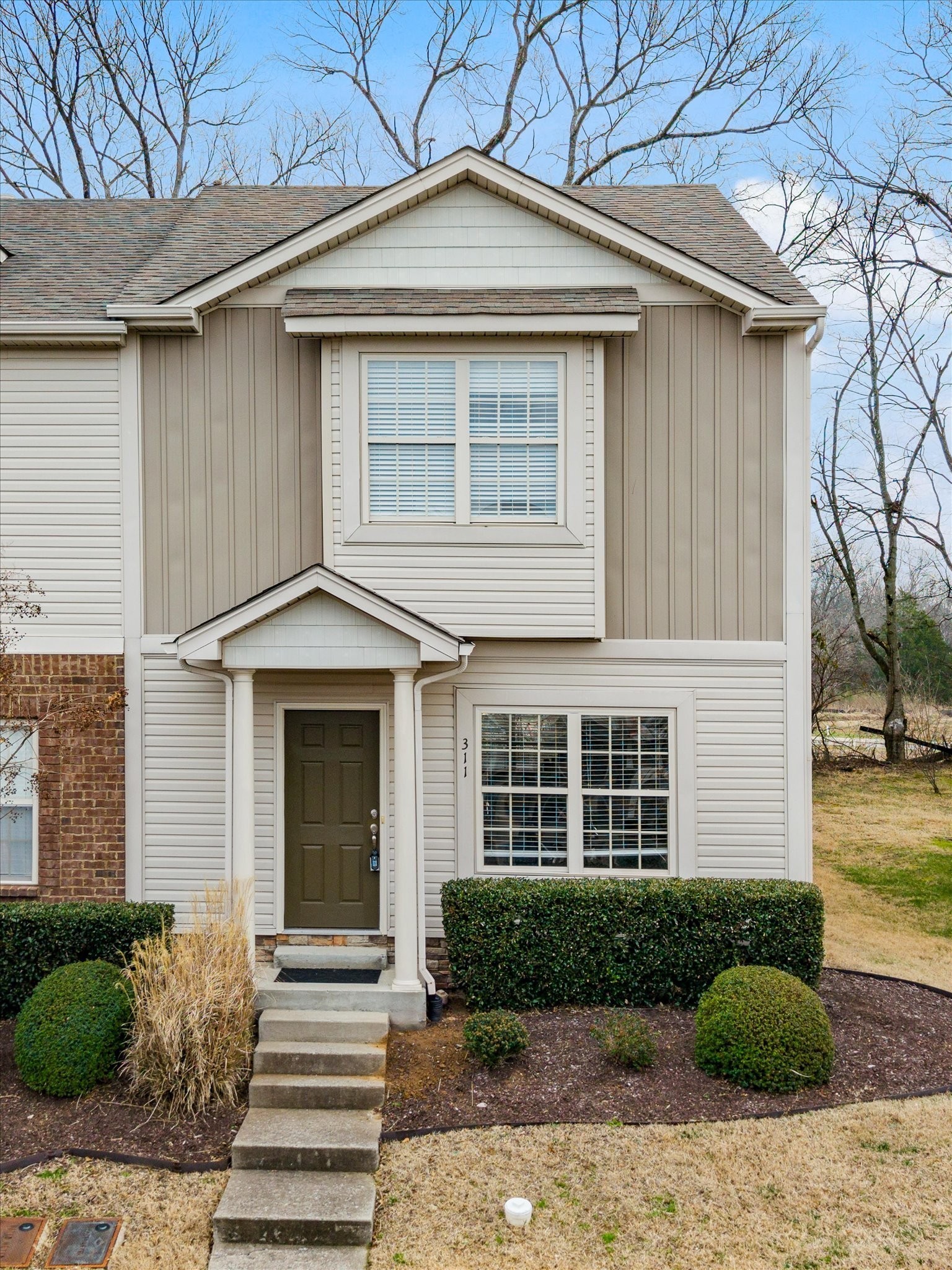 735 Tulip Grove Road, Unit 311 Hermitage, TN 37076 - Photo 2 of 22 a front view of a house with a yard