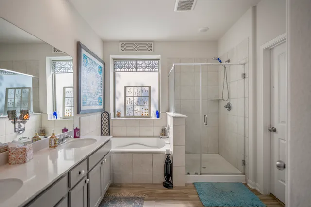 a kitchen with stainless steel appliances kitchen island granite countertop a dining table chairs sink and microwave