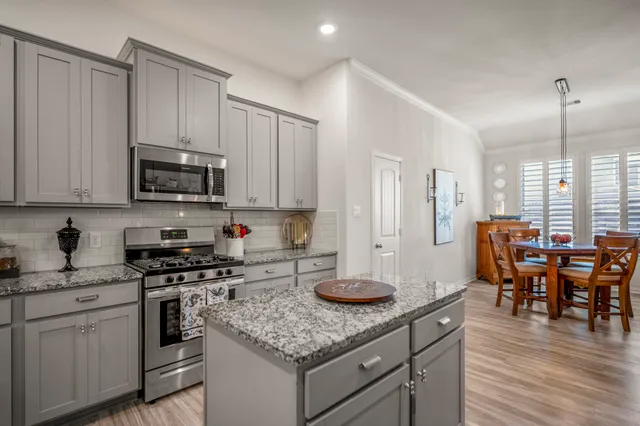 a kitchen with counter top space appliances and cabinets