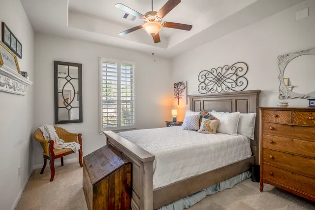 a bedroom with a bed and a lamp on dresser