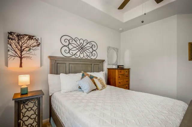 a bedroom with a bed and a chandelier