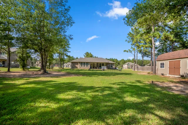 a backyard of a house with table and chairs