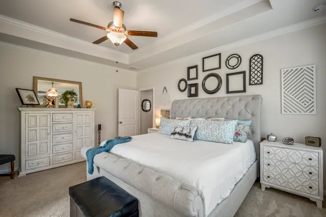 a bedroom with a bed and a dresser in it