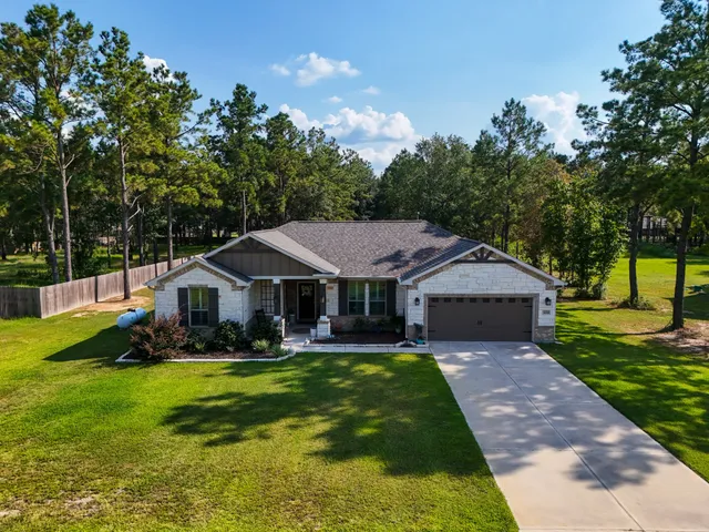 a house view with swimming pool in front of it