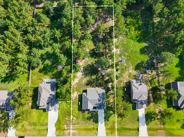 a aerial view of a house with a yard basket ball court and outdoor seating