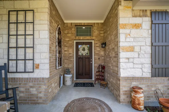 a front view of a house with outdoor seating and plants