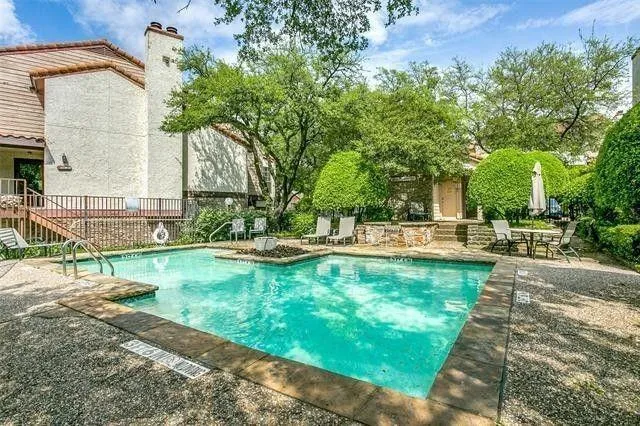 a view of a backyard with sitting area