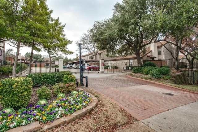a front view of a house with a yard and a garden