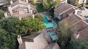 an aerial view of a house with garden space and street view