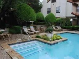 a view of a house with backyard swimming pool and sitting area