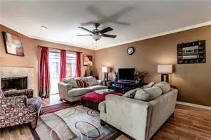 a living room with furniture a fireplace and a flat screen tv