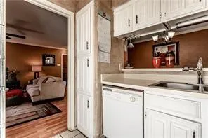 a kitchen with a refrigerator and cabinets