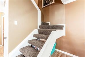 5626 Preston Oaks Road, Unit 39C Dallas, TX 75254 - Photo 33 of 38 Staircase featuring baseboards and wood finished floors