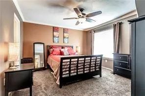 a bedroom with a bed window and dresser