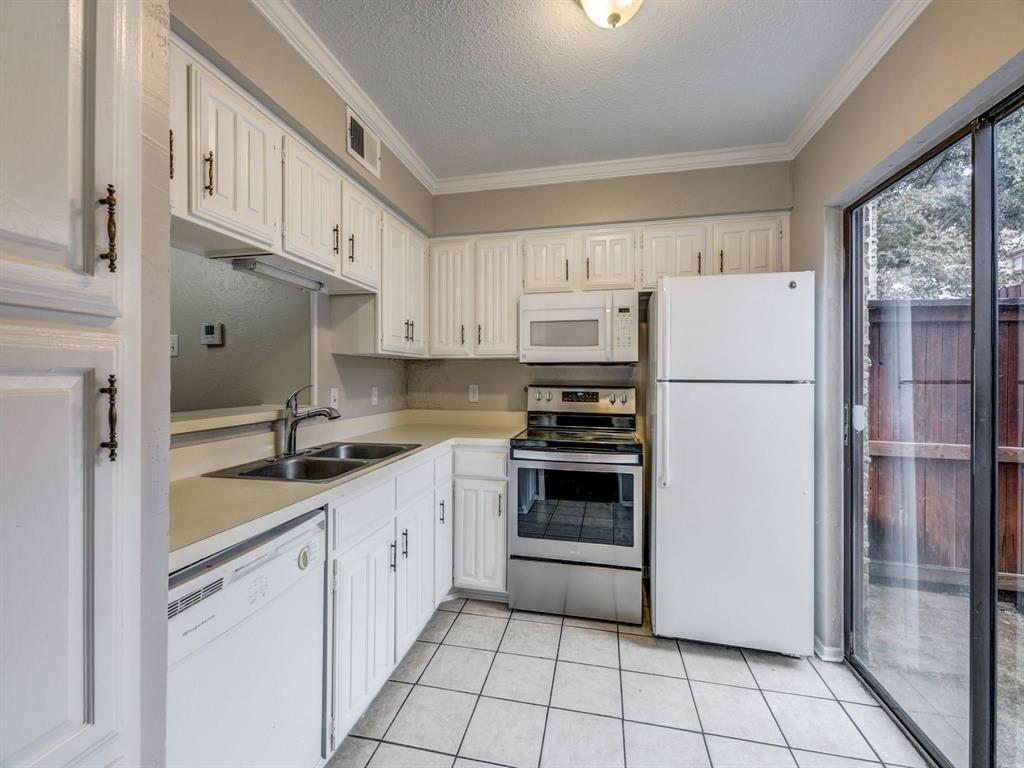 5626 Preston Oaks Road, Unit 39C Dallas, TX 75254 - Photo 4 of 38 Kitchen featuring white appliances, light countertops, ornamental molding, a textured ceiling, and light tile patterned flooring