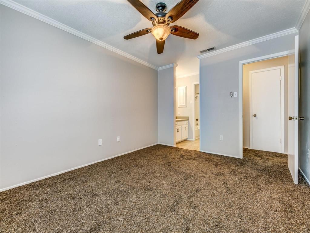 5626 Preston Oaks Road, Unit 39C Dallas, TX 75254 - Photo 7 of 38 Unfurnished bedroom featuring crown molding, light colored carpet, connected bathroom, and ceiling fan