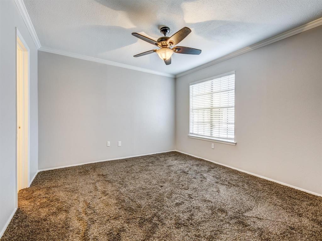 5626 Preston Oaks Road, Unit 39C Dallas, TX 75254 - Photo 9 of 38 Empty room featuring crown molding, carpet, a textured ceiling, and a ceiling fan