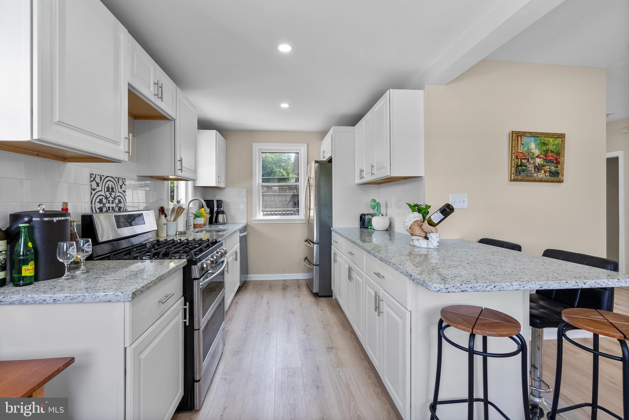 8020 Old Philadelphia Road Baltimore, MD 21237 - Photo 12 of 37 a kitchen with granite countertop a stove top oven a sink a counter space and cabinets