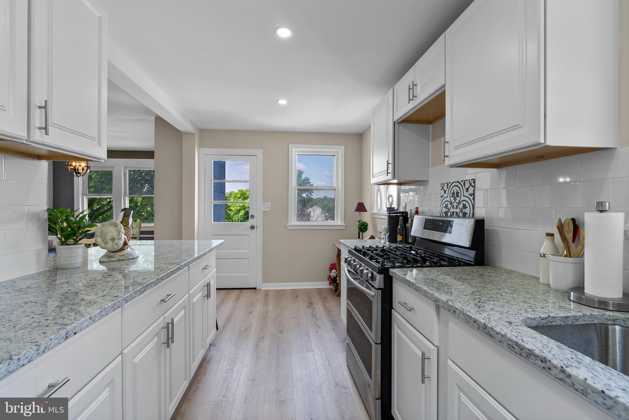8020 Old Philadelphia Road Baltimore, MD 21237 - Photo 13 of 37 a kitchen with granite countertop a sink stove and cabinets