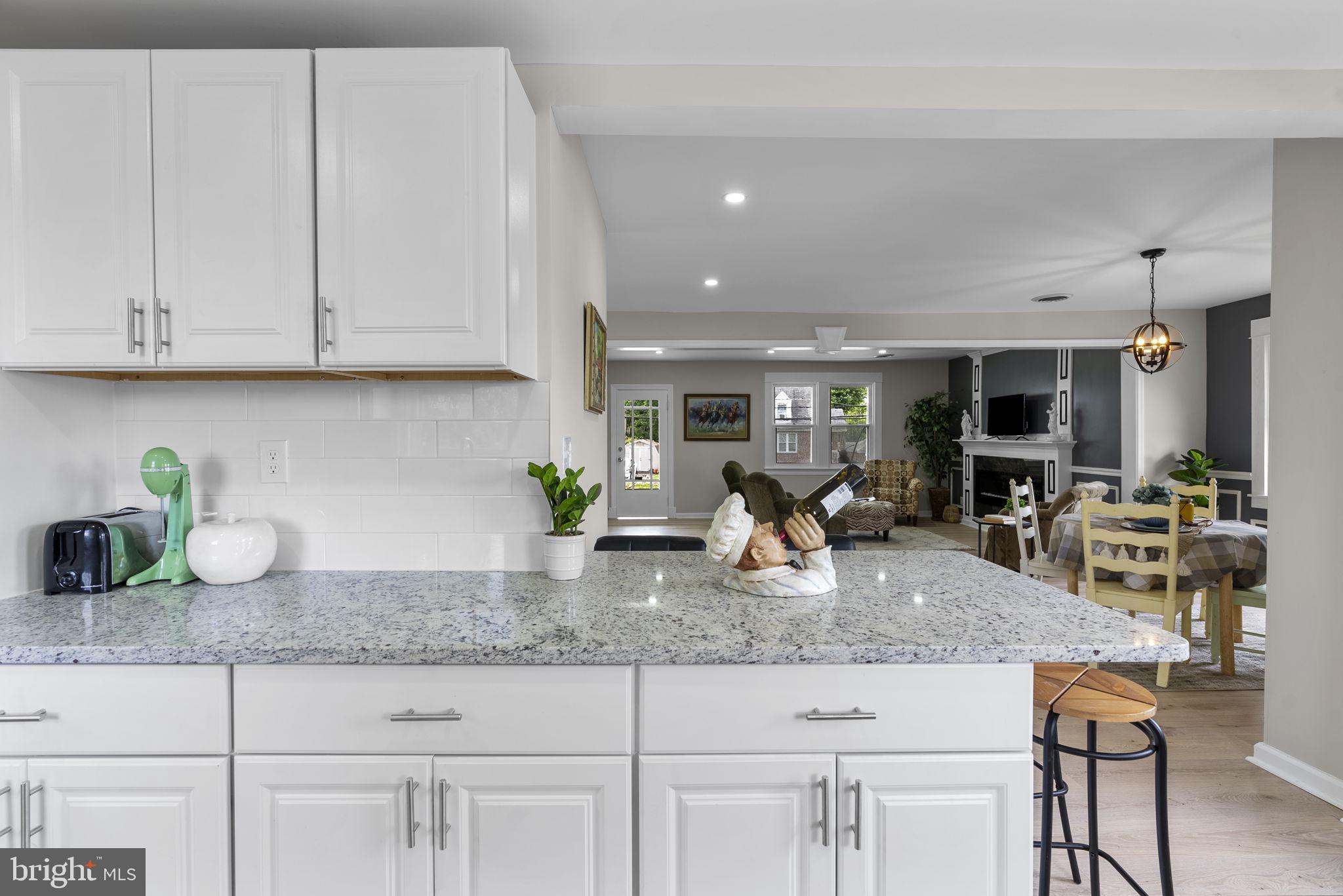 8020 Old Philadelphia Road Baltimore, MD 21237 - Photo 14 of 37 a kitchen with granite countertop a white cabinets and chairs
