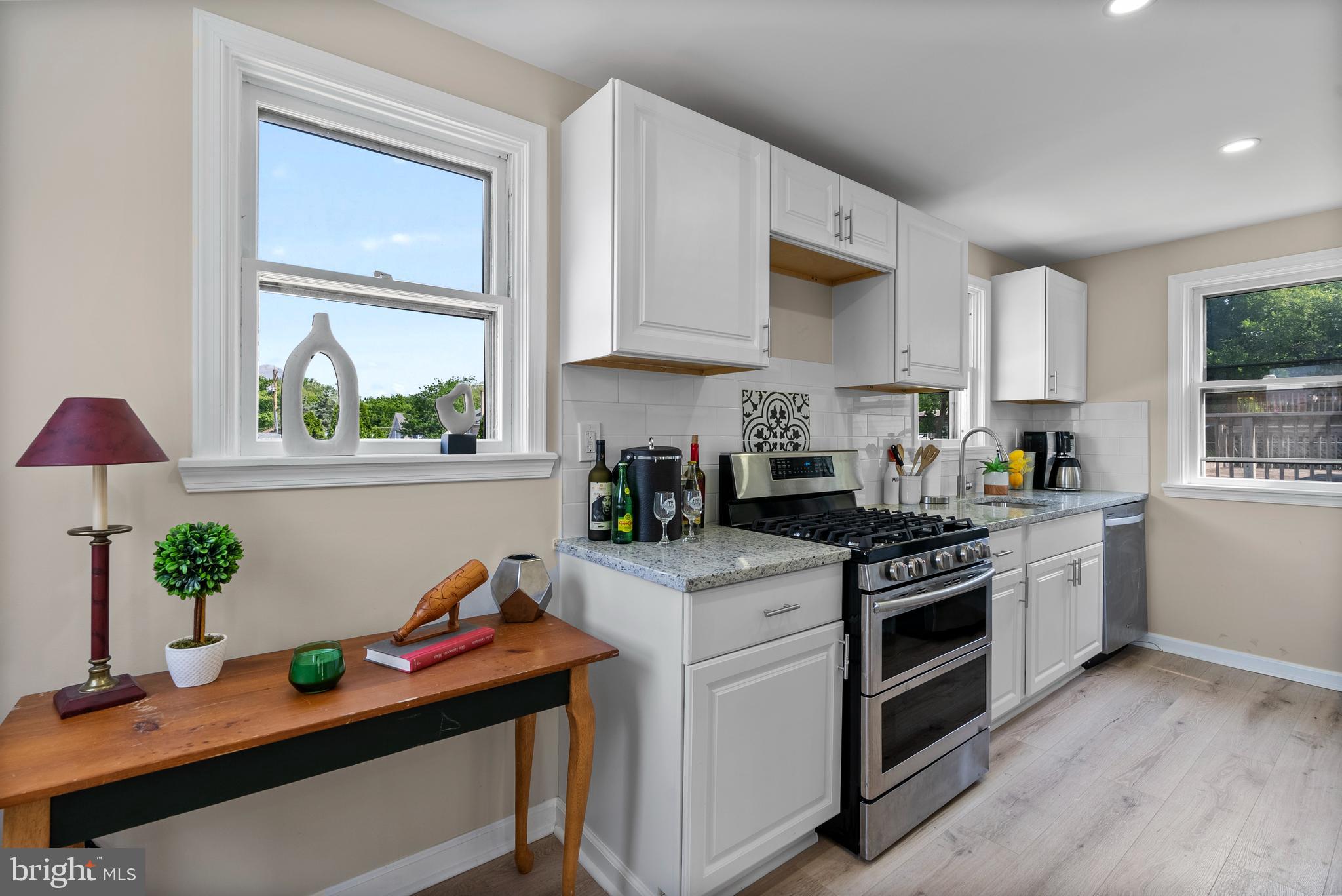 8020 Old Philadelphia Road Baltimore, MD 21237 - Photo 15 of 37 a kitchen with stainless steel appliances a stove a sink cabinets and a window