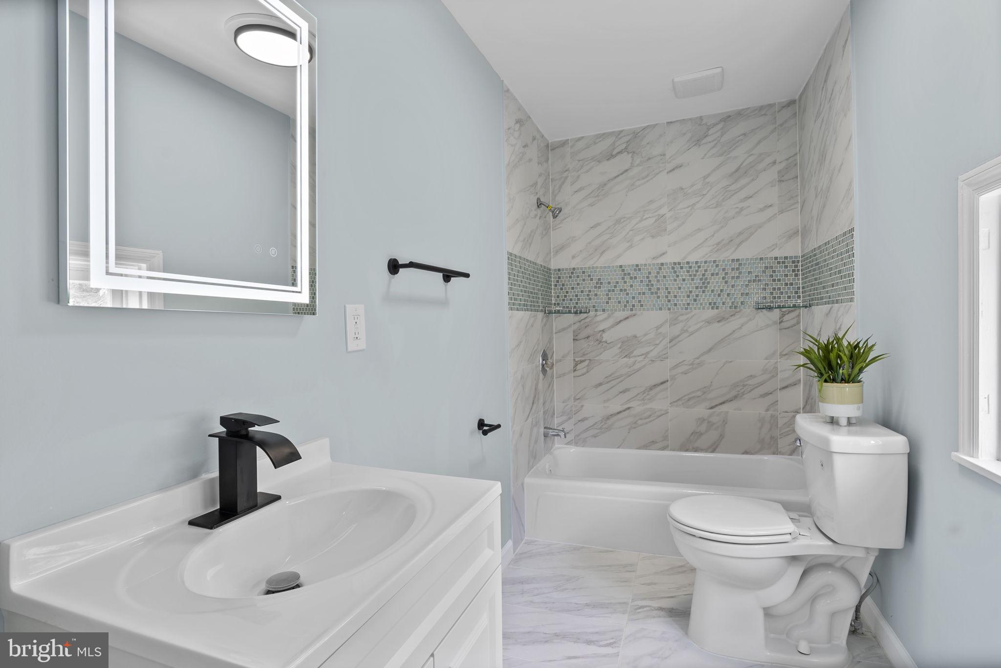 8020 Old Philadelphia Road Baltimore, MD 21237 - Photo 17 of 37 a bathroom with a sink a toilet and shower