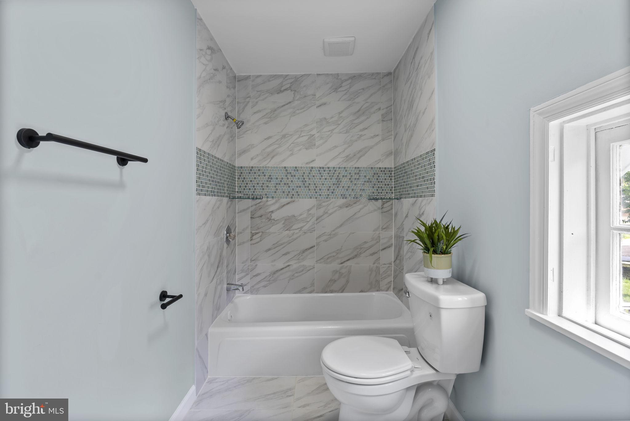 8020 Old Philadelphia Road Baltimore, MD 21237 - Photo 18 of 37 a bathroom with a toilet and a bathtub