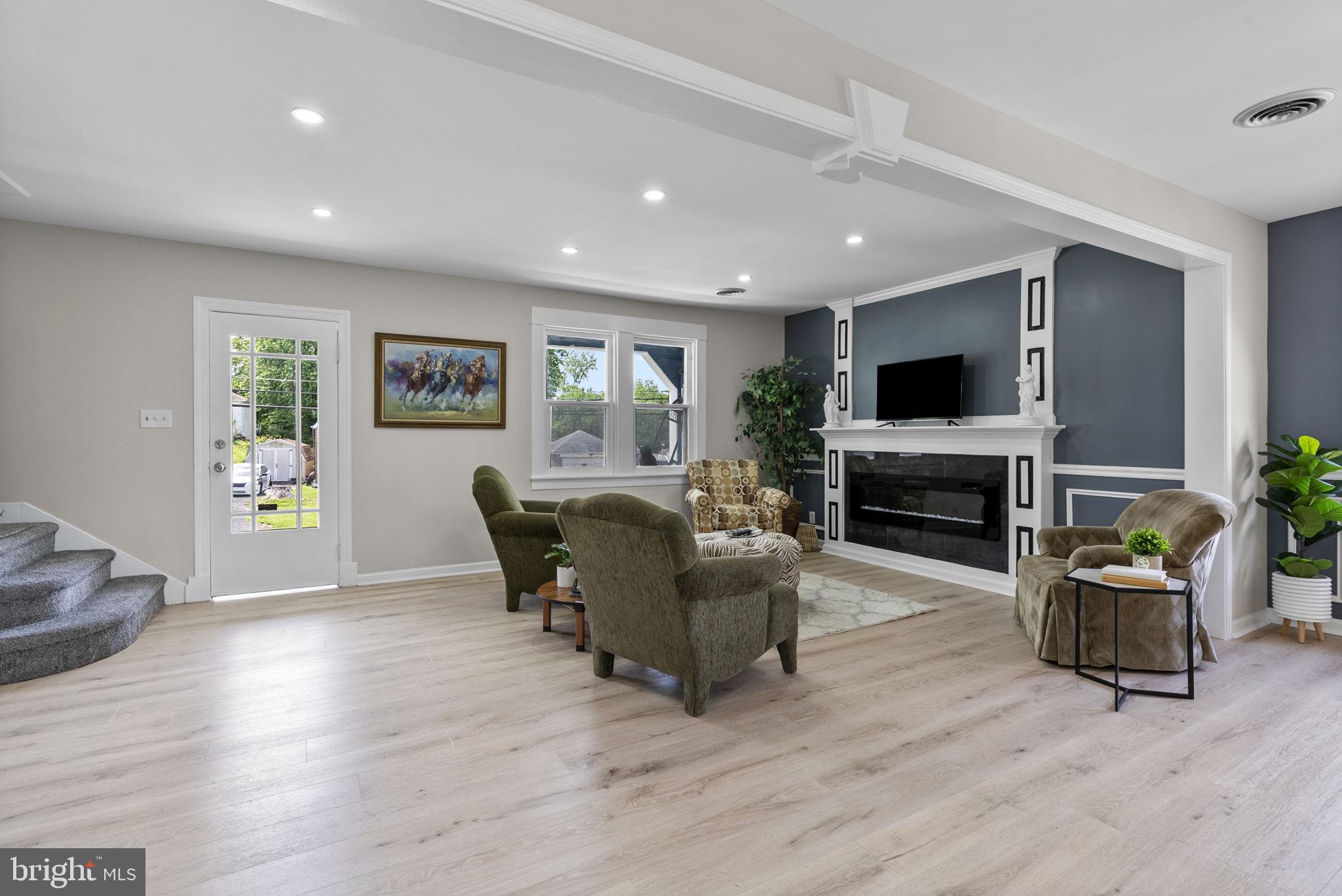 8020 Old Philadelphia Road Baltimore, MD 21237 - Photo 7 of 37 a living room with furniture a fireplace and a flat screen tv