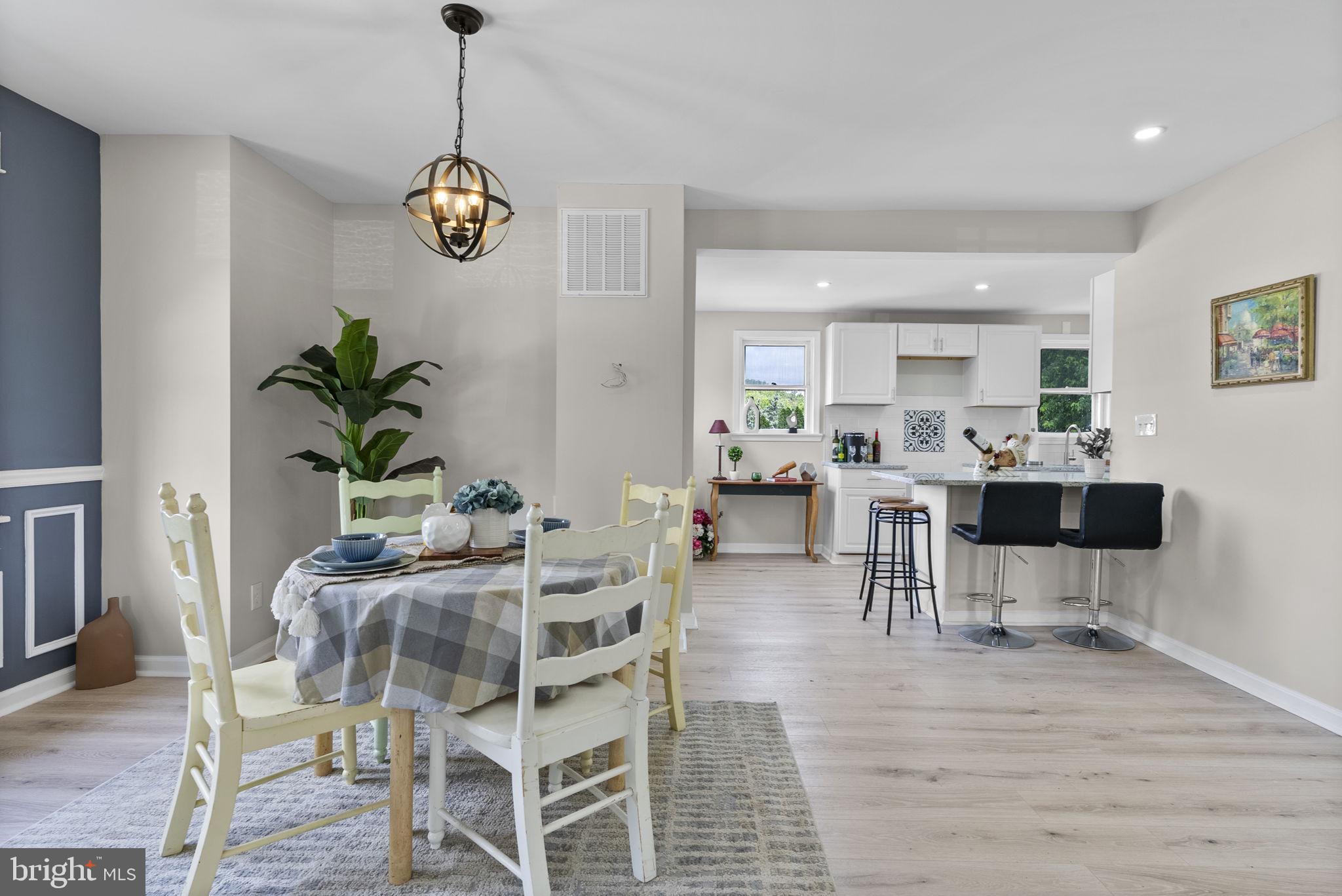 8020 Old Philadelphia Road Baltimore, MD 21237 - Photo 10 of 37 a dining room filled chandelier and kitchen view