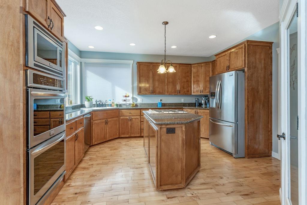 1042 Pumpkin Ridge Eagle Point, OR 97524 - Photo 6 of 34 a kitchen with stainless steel appliances granite countertop a refrigerator a stove a sink and a oven
