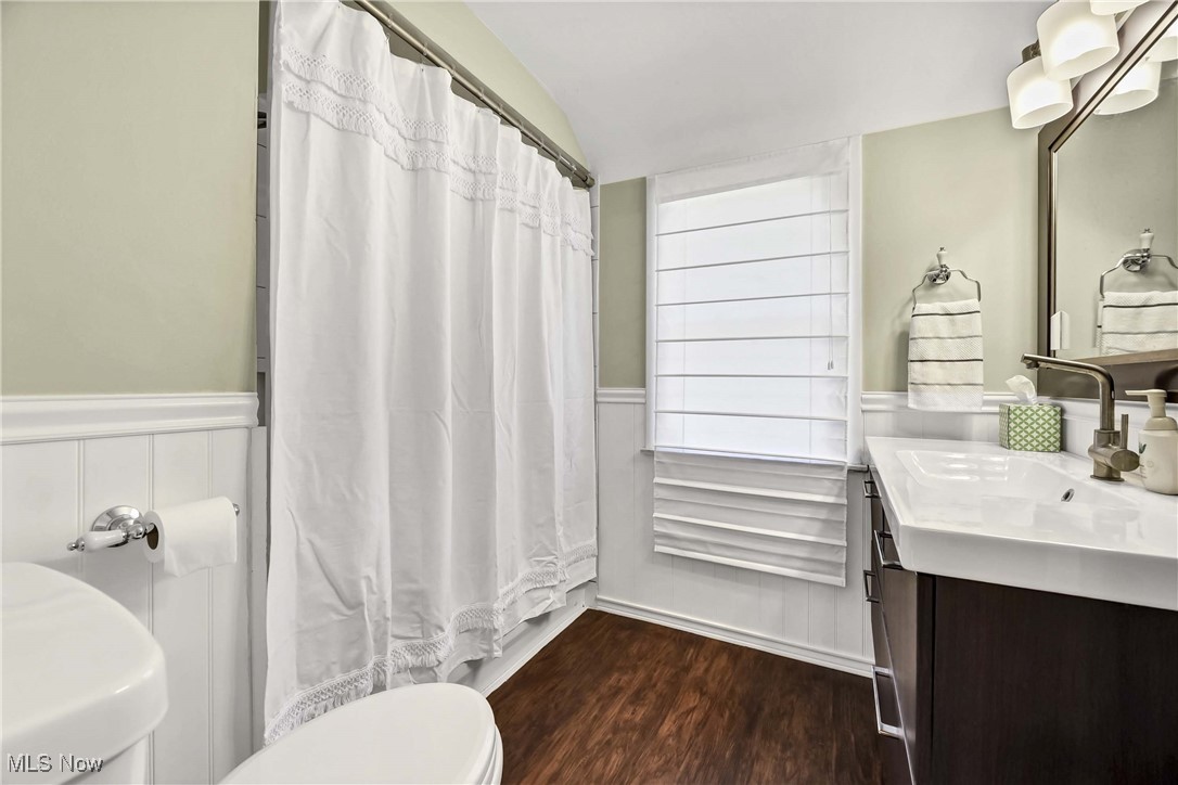 1204 Brainard Road Lyndhurst, OH 44124 - Photo 26 of 34 Bathroom featuring a shower with curtain, hardwood / wood-style flooring, vanity, and toilet