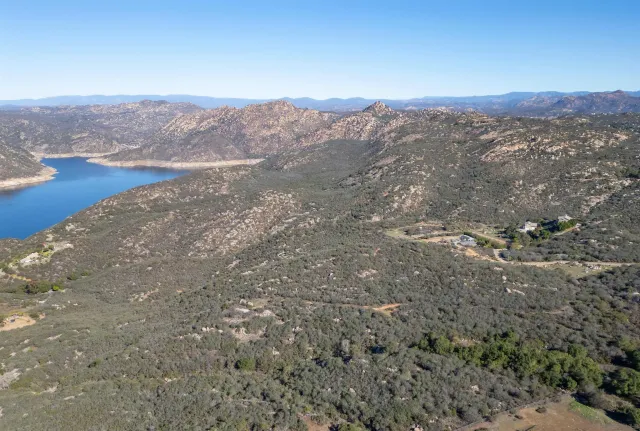 a view of a dry yard with mountains in the background
