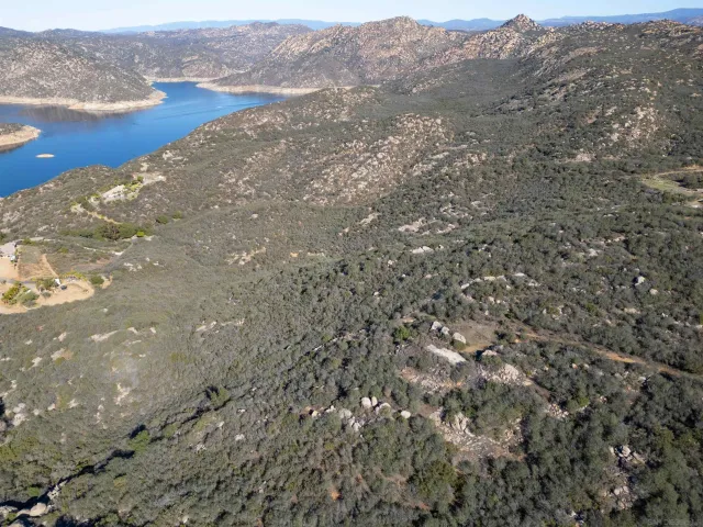 a view of a field with mountains in the background