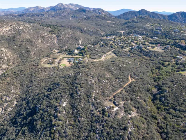 a view of a yard with wooden fence