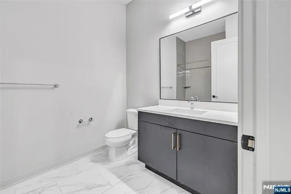 a bathroom with a sink toilet and mirror