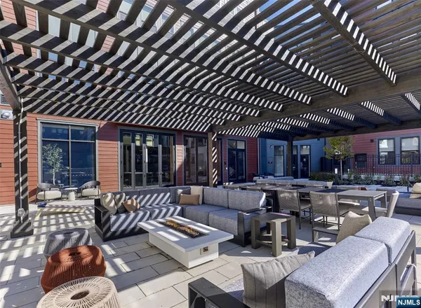 a view of a patio with couches table and chairs with wooden floor