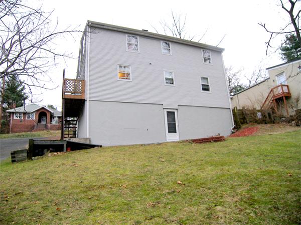 64 Bertwell Road Lexington, MA 02420 - Photo 18 of 18 a view of a white house in front of a big yard