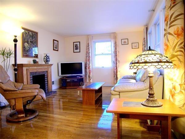 64 Bertwell Road Lexington, MA 02420 - Photo 3 of 18 a living room with furniture a flat screen tv and a fireplace