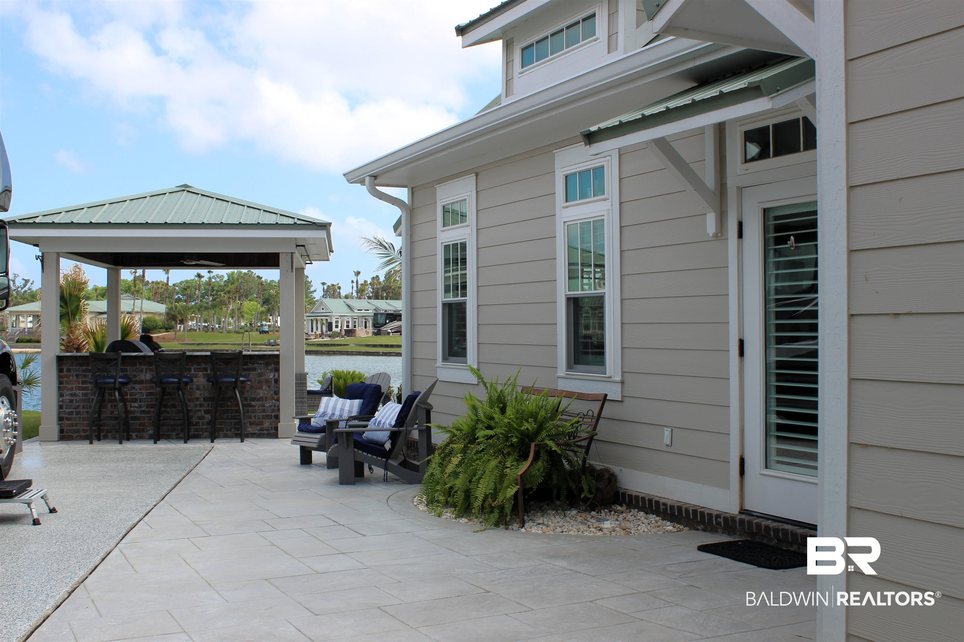 28058 Migratory Way, Unit 100 Elberta, AL 36530 - Photo 12 of 83 View of patio / terrace featuring an outdoor kitchen, a gazebo, outdoor dry bar, and a water view