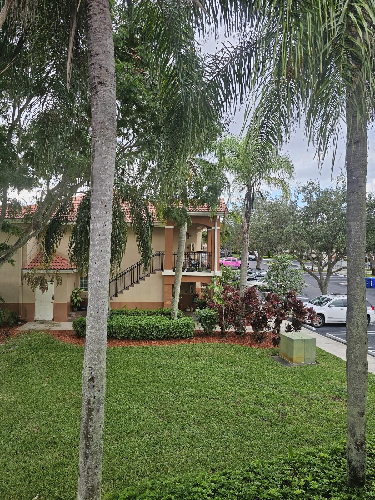 3490 Briar Bay Boulevard, Unit 206 West Palm Beach, FL 33411 - Photo 25 of 25 a front view of a house with garden
