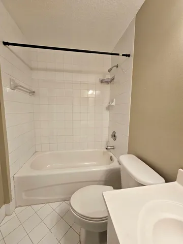 a bathroom with a sink a toilet and a bathtub