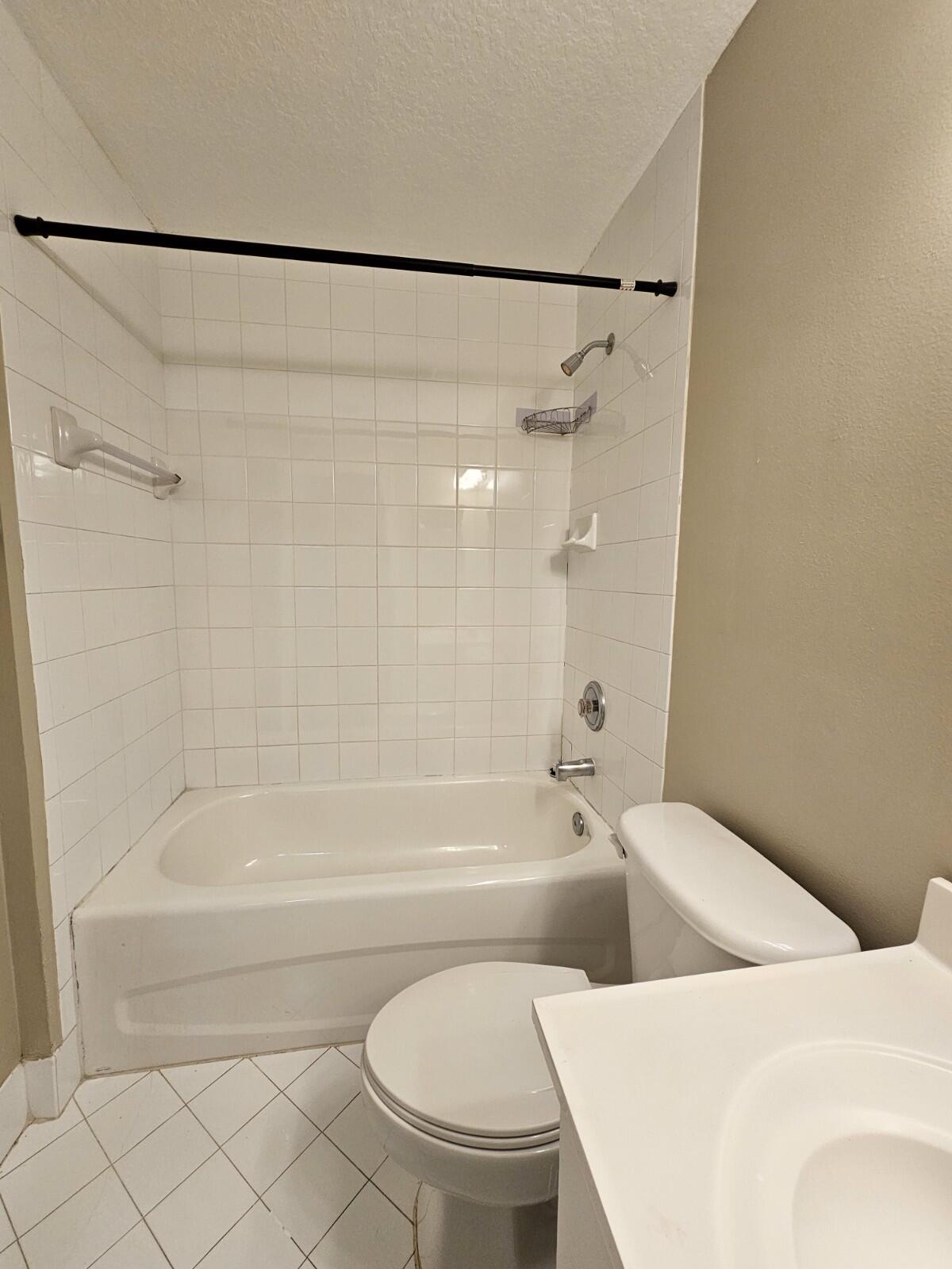 3490 Briar Bay Boulevard, Unit 206 West Palm Beach, FL 33411 - Photo 9 of 25 a bathroom with a bathtub and a shower