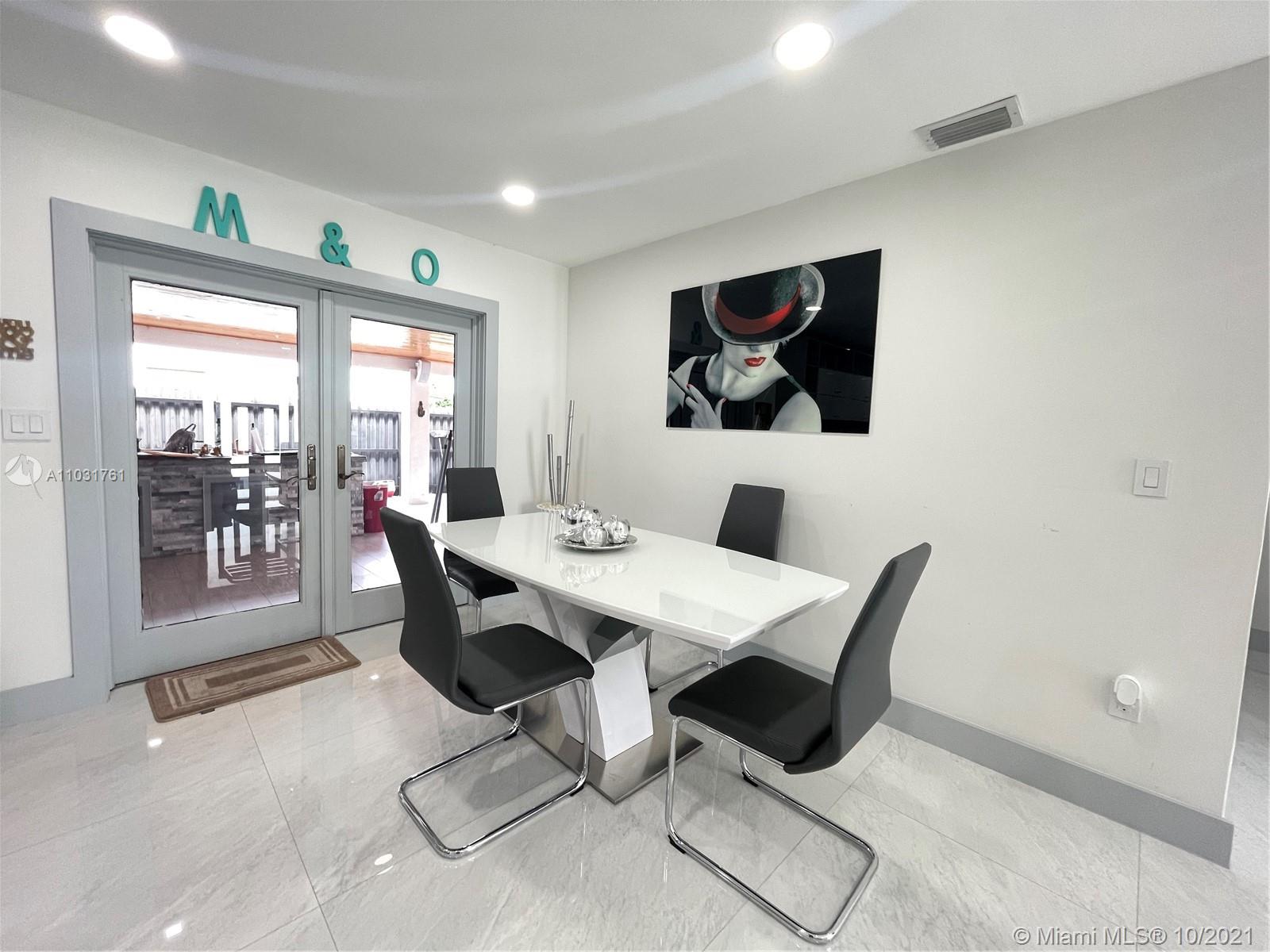 3541 Southwest 105th Court Miami, FL 33165 - Photo 12 of 45 a view of a dining room with a table and chairs